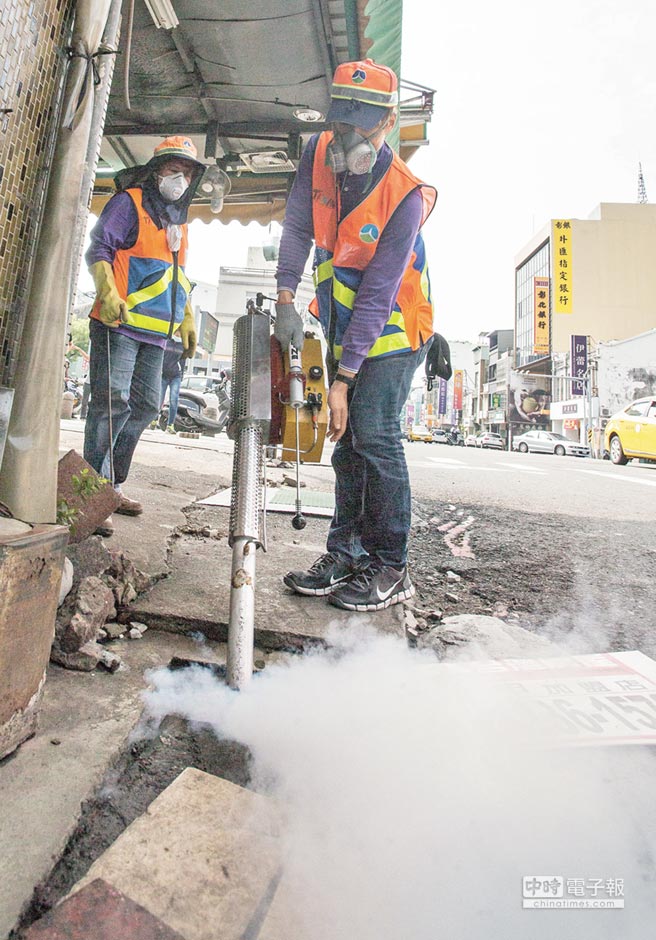 登革熱疫情持續(xù)嚴重，臺南市環(huán)保局工作人員到水仙宮市場外進行水溝消毒工作。（《中國時報》 黃仲裕攝）