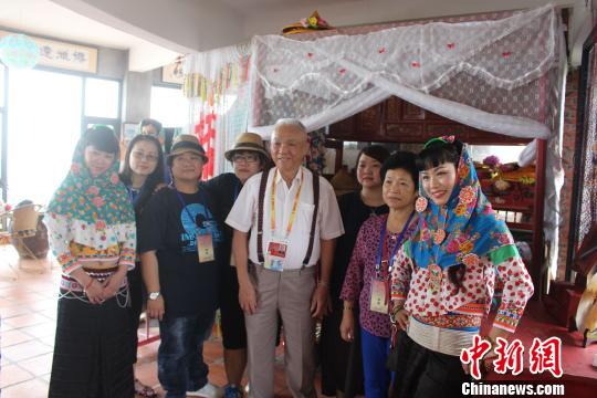 6月12日，來自臺灣基隆的8旬臺胞張細(xì)山回到祖籍地參觀村內(nèi)的惠安女民俗風(fēng)情園，攜家族成員與“惠安女”合影?！×戊o 攝